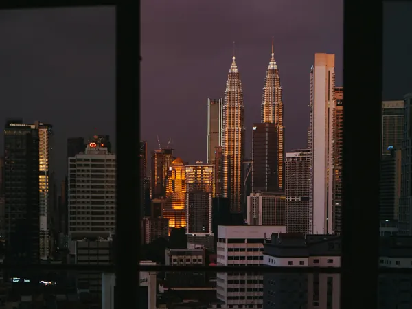 The Petronas Towers at dusk, framed by the living room window